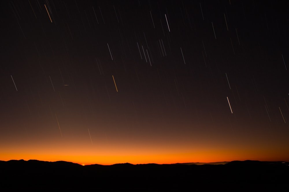 silhouette of hill during night time